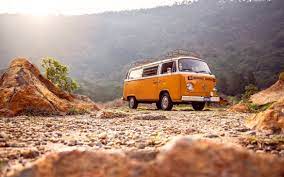 „Nowoczesny biały bus 9-osobowy zaparkowany na tle gór Beskidów, gotowy do wynajmu w wypożyczalni samochodów w gminie Ciściesz, idealny na rodzinne i grupowe wyjazdy.”